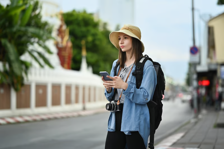 wisatawan menggunakan ponsel untuk mengakses internet saat bepergian ke luar negeri